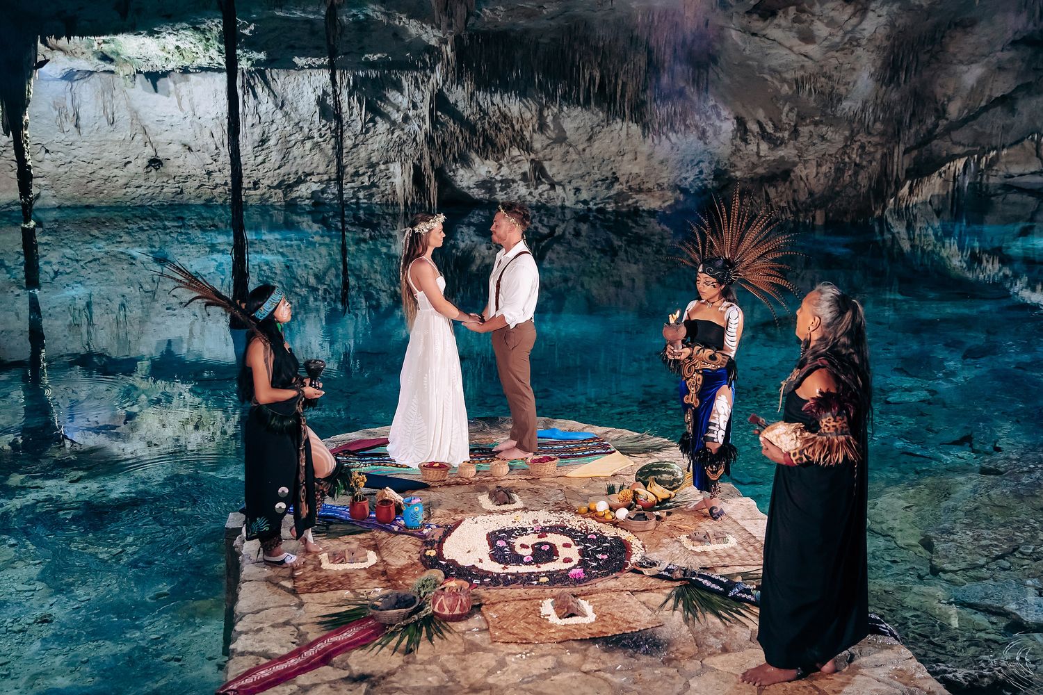 Celebration setup in a mystical cave environment with decorative lighting and tables.