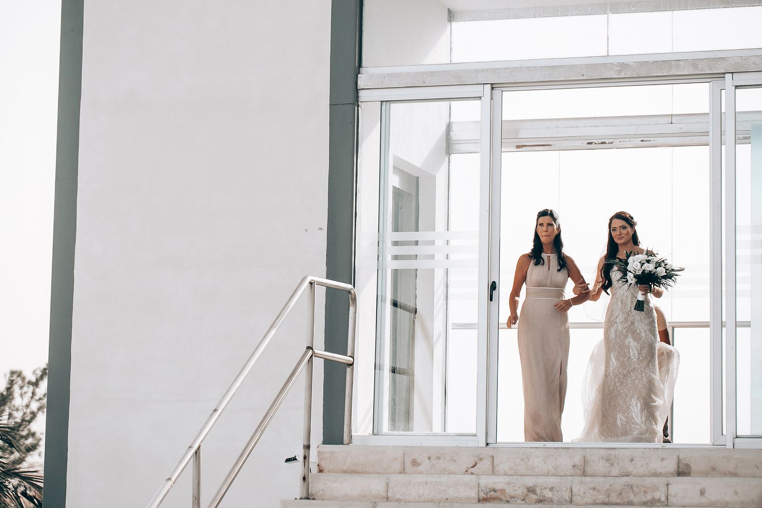 A bright white interior space with multiple dress forms displaying elegant wedding gowns and bridal attire.