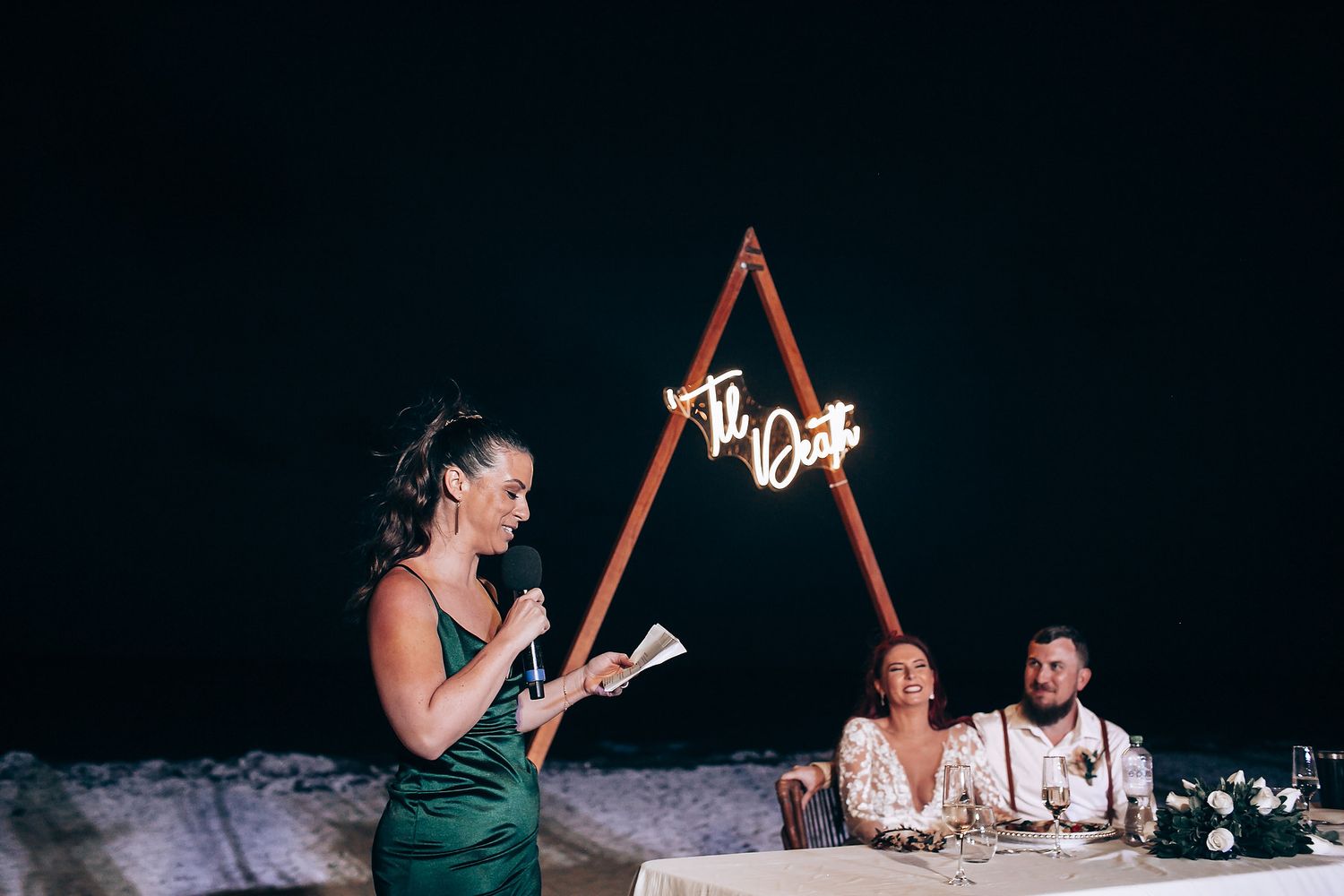 Evening wedding reception with string lights creating romantic ambiance.