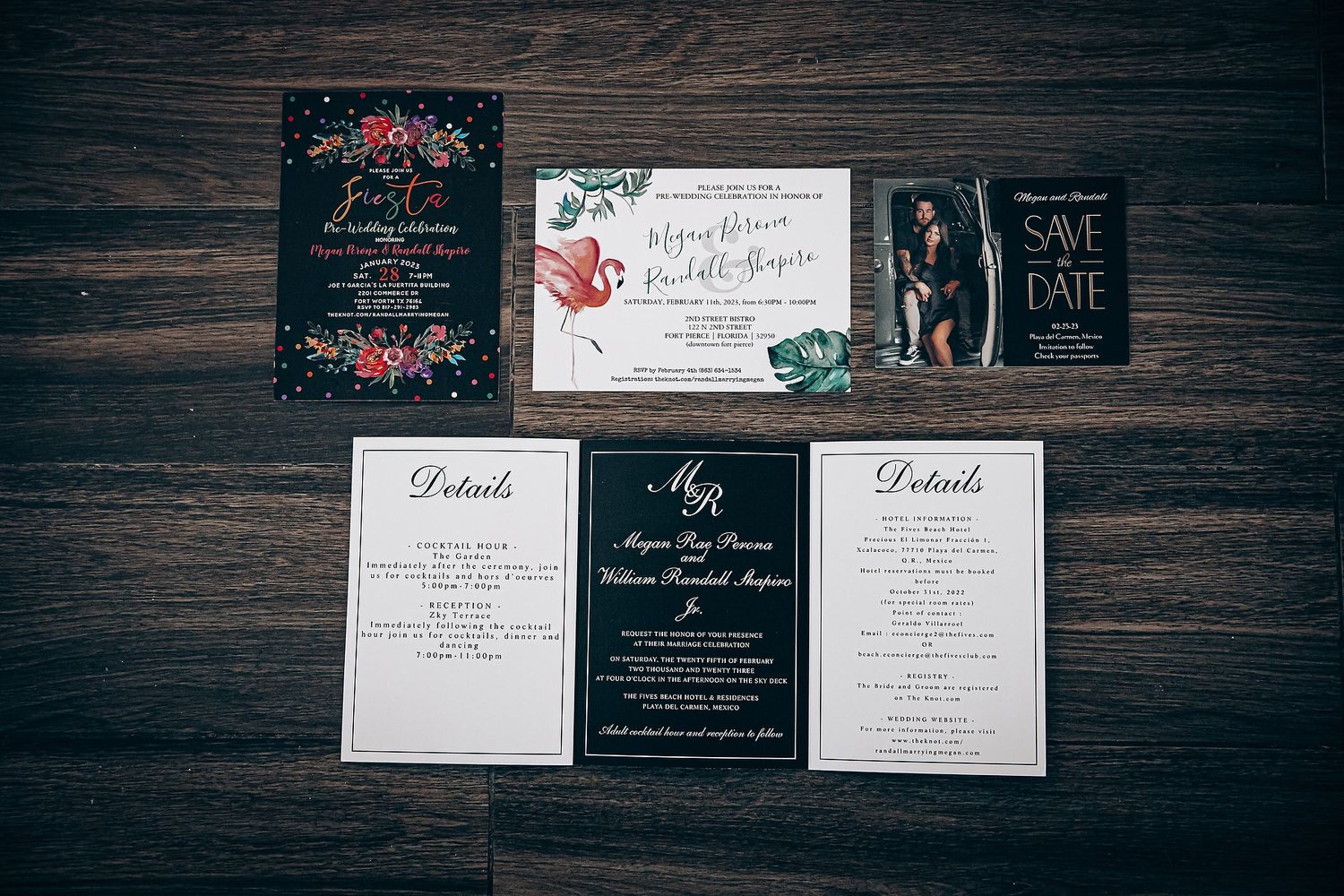 Elegant wedding invitation suite with black and white cards featuring calligraphy displayed on dark wooden surface.