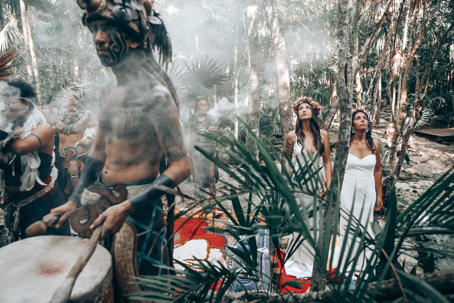 A romantic outdoor photo session in a lush tropical garden setting with soft natural lighting and palm fronds.