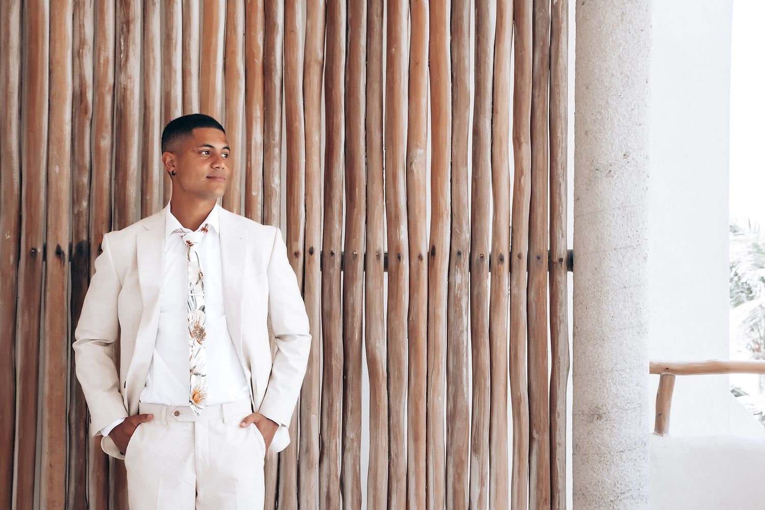 Elegant wedding preparation scene with white decor and bamboo details in a tropical setting.