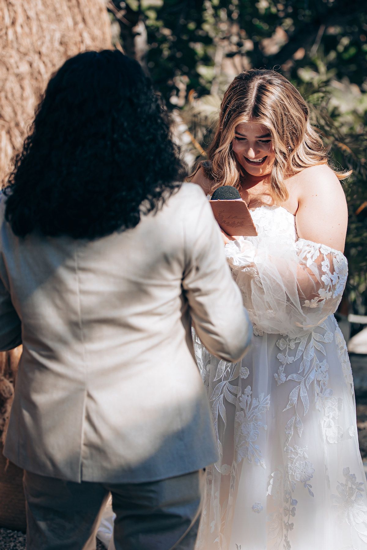 A sequence of wedding photos shows a couple in white embracing and dancing together outdoors.