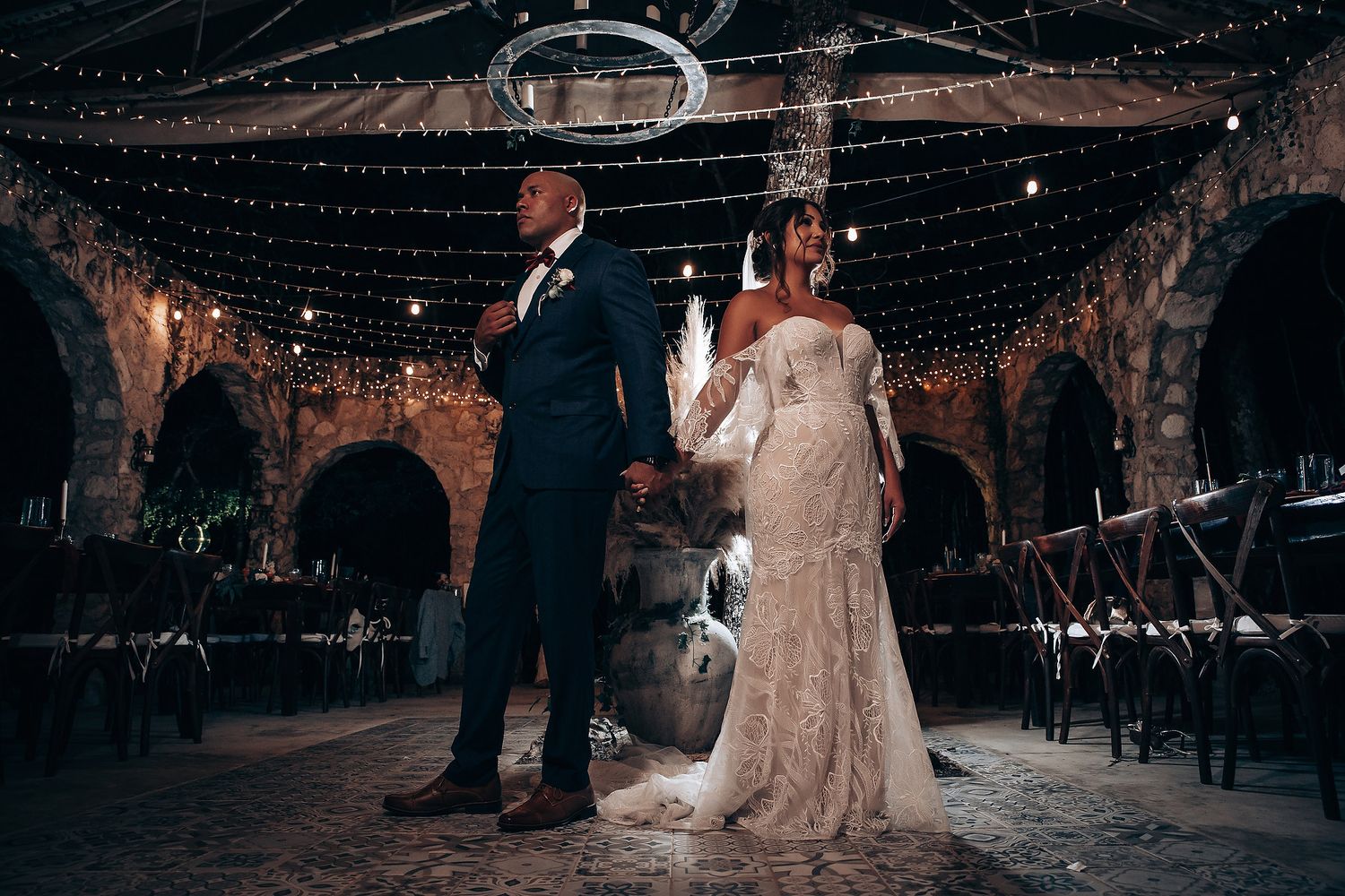Wedding reception venue decorated with string lights creating a magical nighttime ambiance.