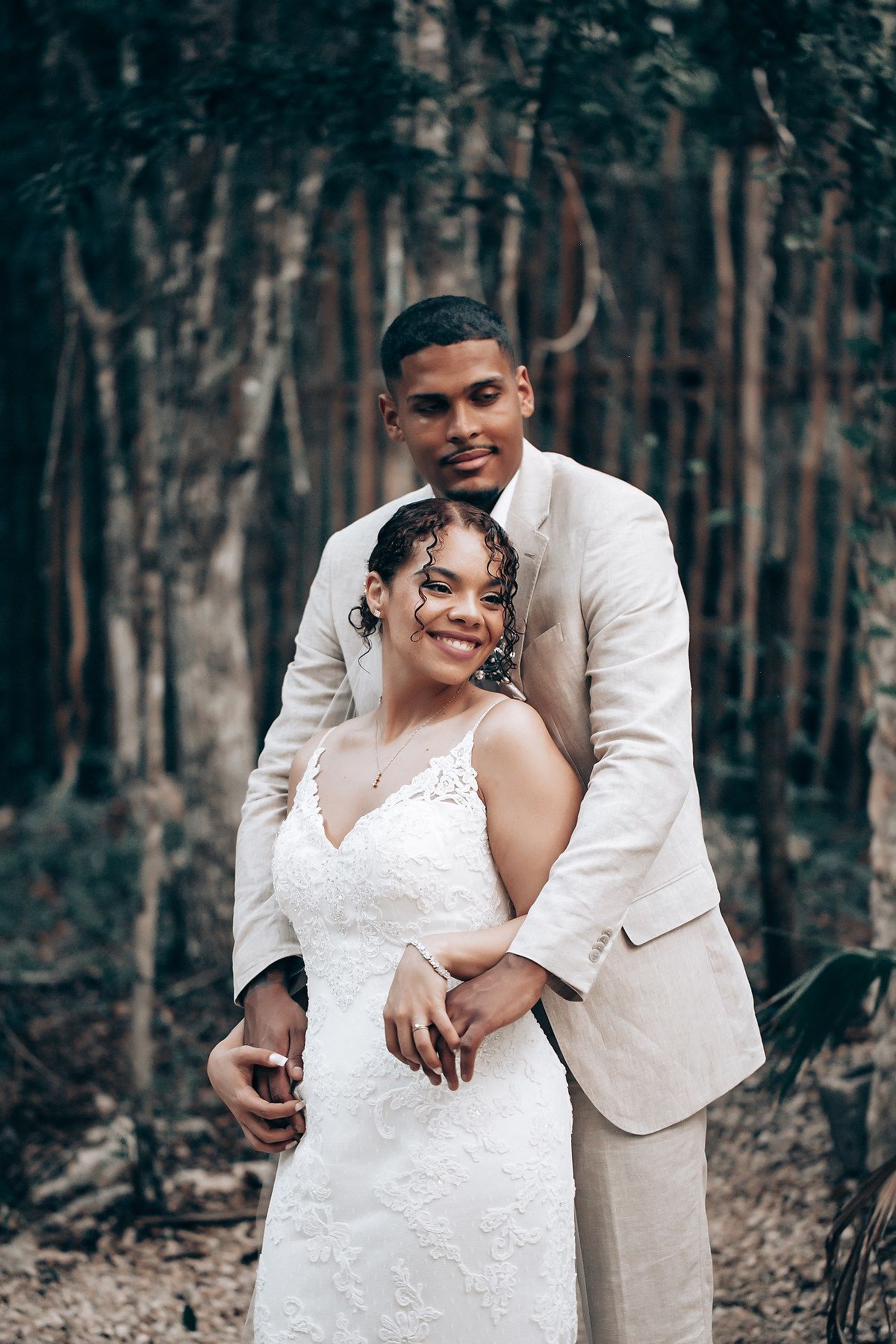 A romantic wedding portrait session in a serene forest setting with natural lighting.