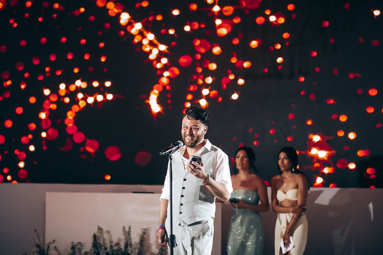 Wedding celebration with red bokeh lights creating a romantic atmosphere.