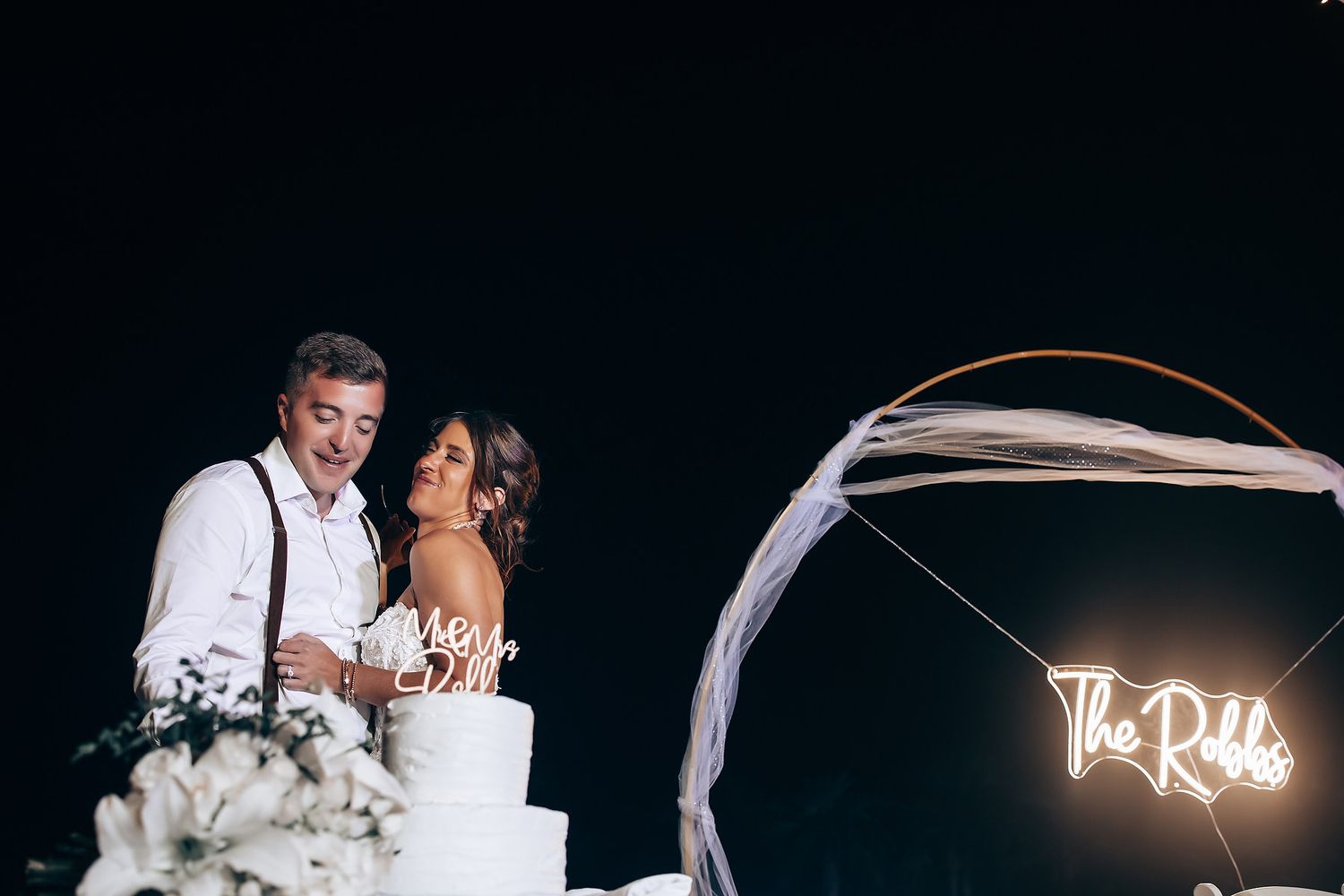 Intimate nighttime wedding reception moments captured under twinkling lights and decorations.