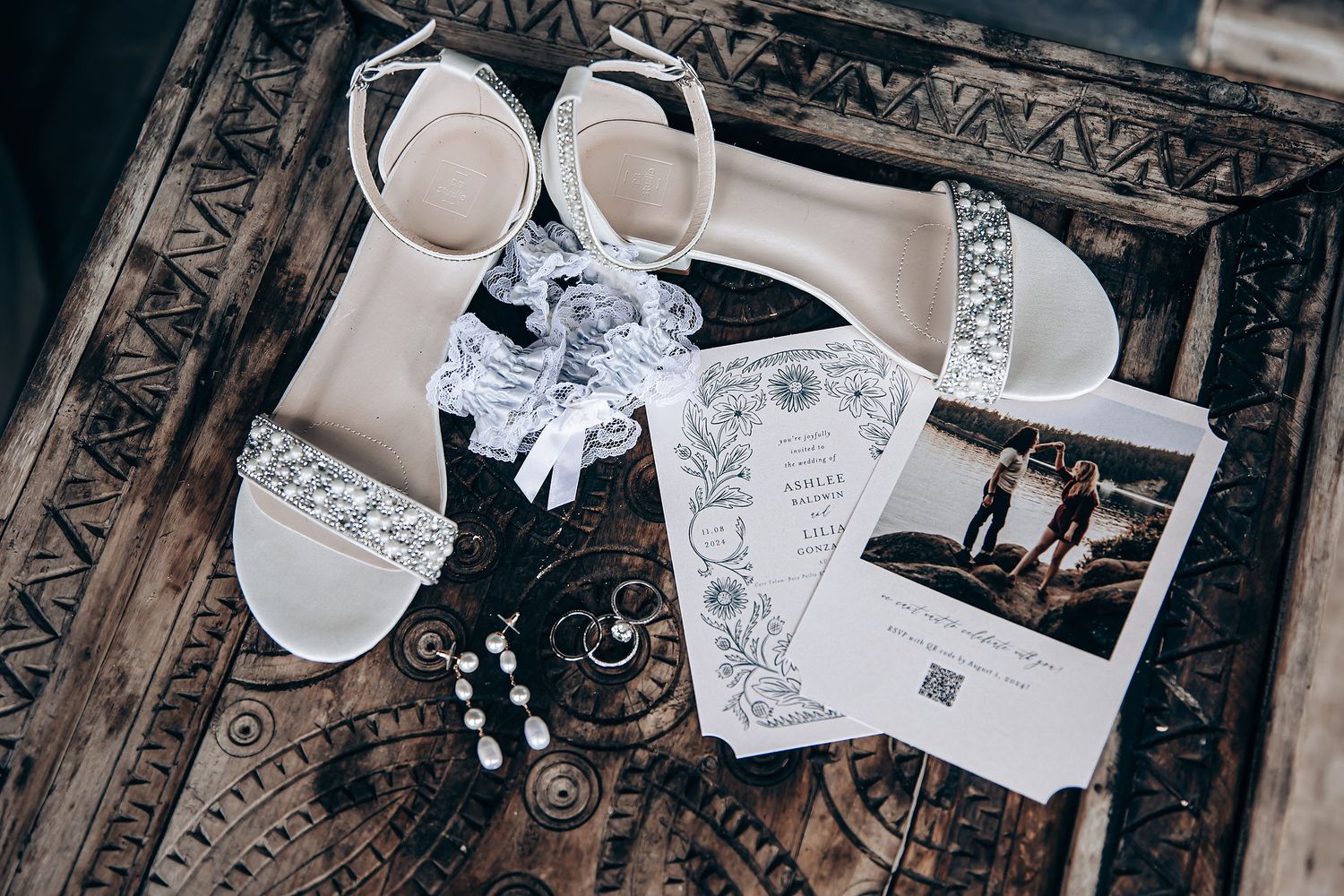 Wedding stationery and invitation details arranged on ornate surface.