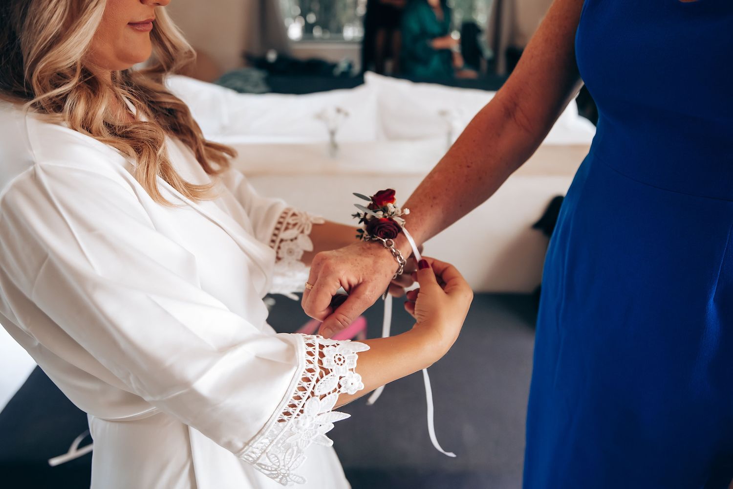 A series of close-up shots showing someone wearing a white lace-detailed wedding dress during a fitting session.