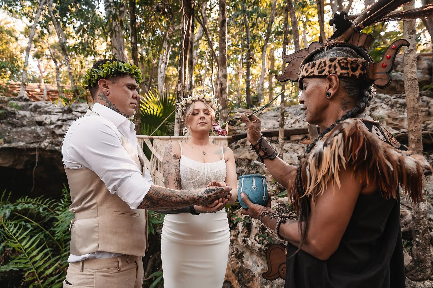 Cultural blessing ceremony being performed in a tropical cave environment.