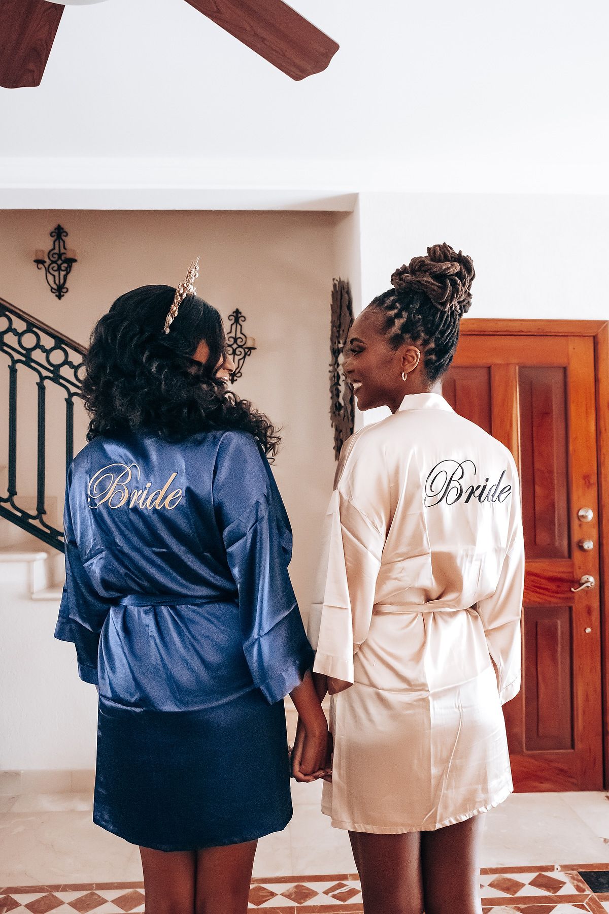 Wedding party members wearing navy blue and cream silk robes prepare for the special day.