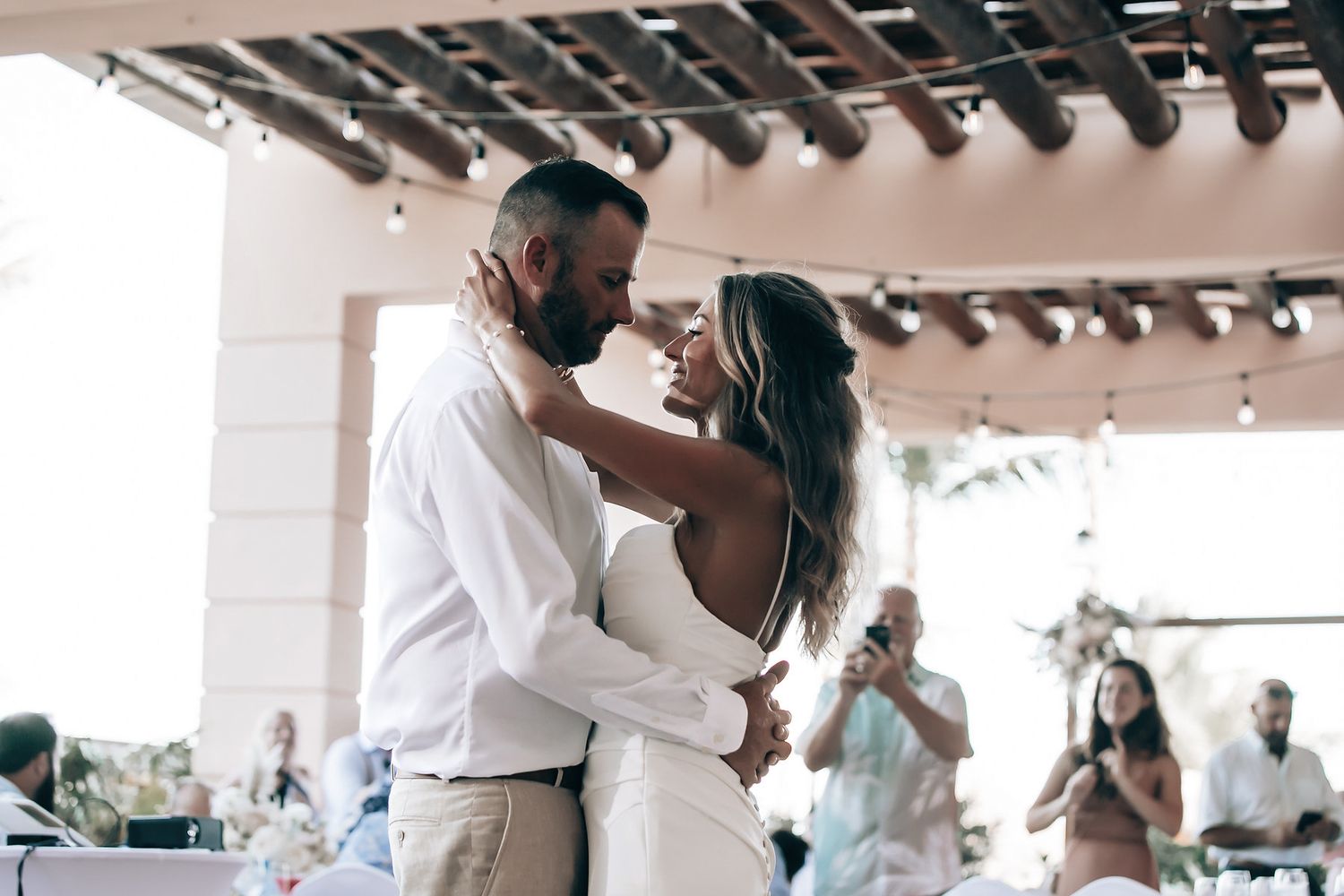 A couple is dancing together at their wedding reception.