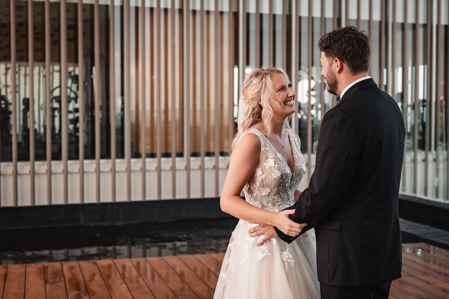 Emotional wedding first look sequence showing couple's reaction in modern venue.