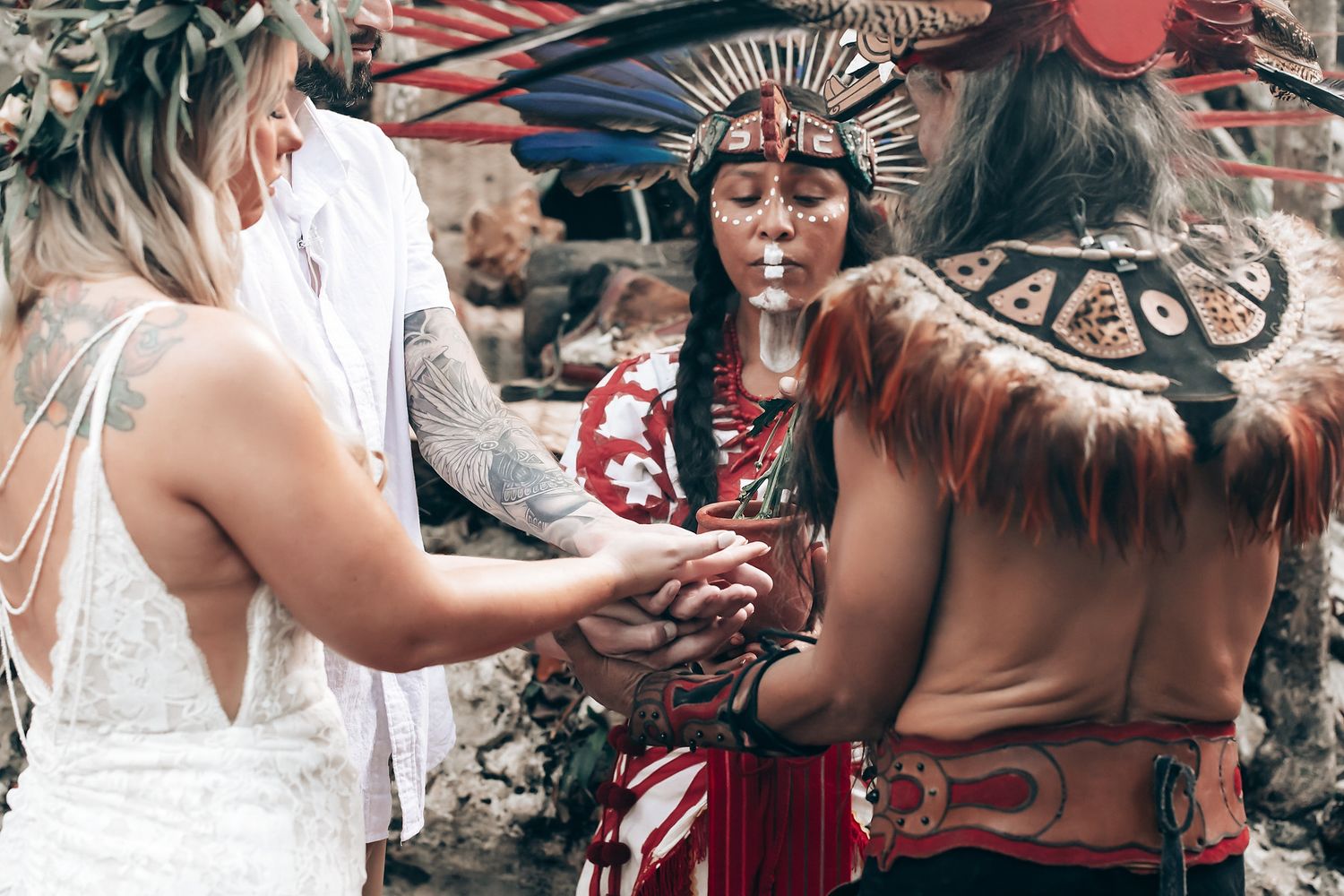 Traditional dancers in ceremonial dress performing during an outdoor celebration.