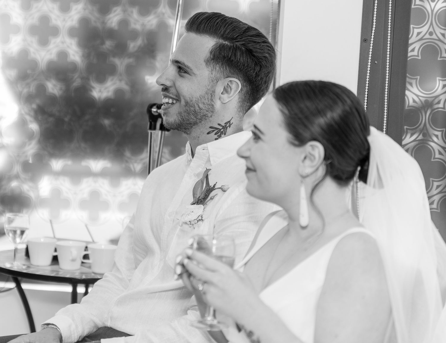 Black and white series of candid wedding moments showing laughter and celebration.