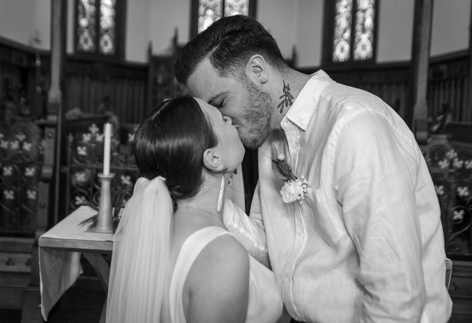Wedding couple sharing intimate moments and laughter in a church setting.