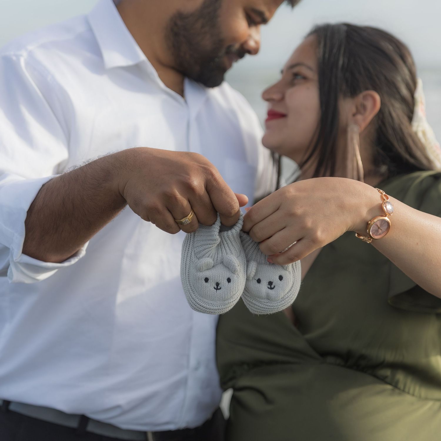 Series of romantic couple poses in white and olive green clothing.
