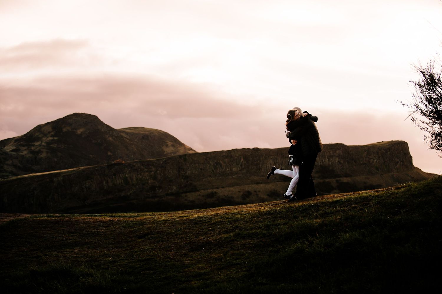 Dramatic silhouettes on a hilltop against a sunset sky.