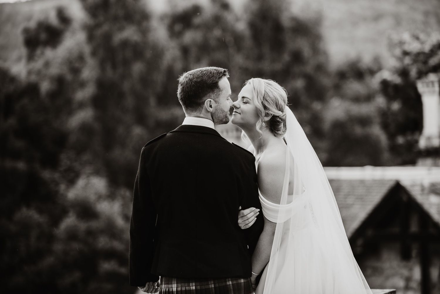 Black and white wedding photos showing tender moments between newlyweds.