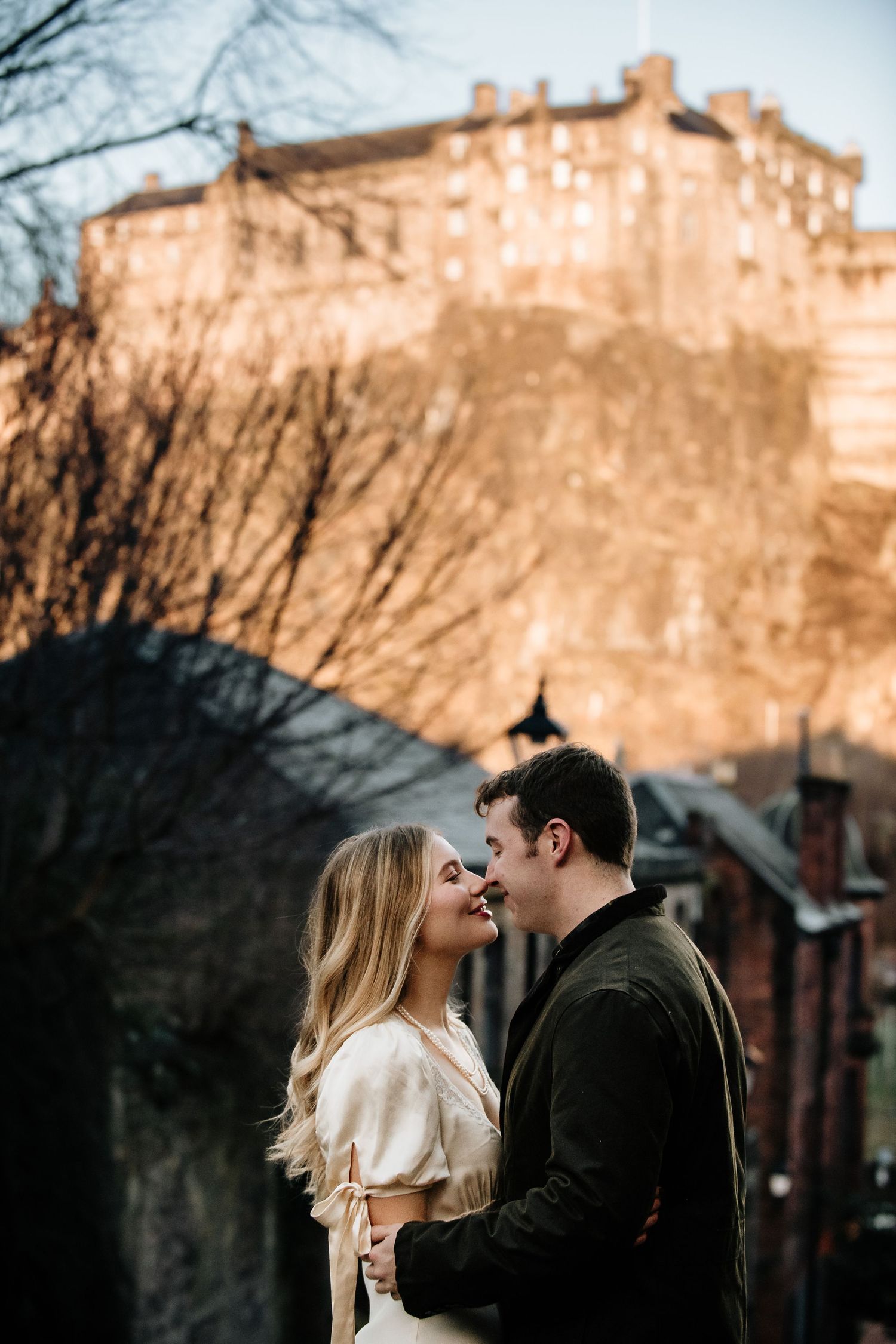Intimate winter scene against the dramatic backdrop of Edinburgh Castle at sunset.