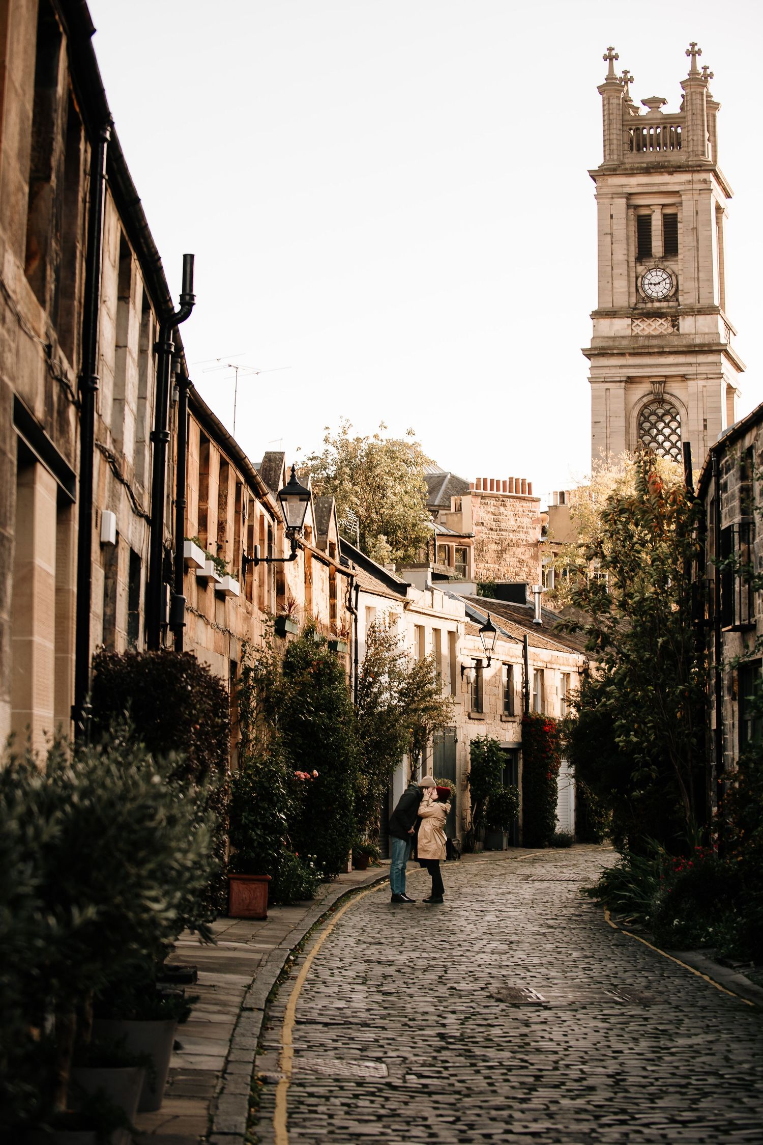 Cobblestone street with church tower and historic buildings in Edinburgh's Circus Lane.