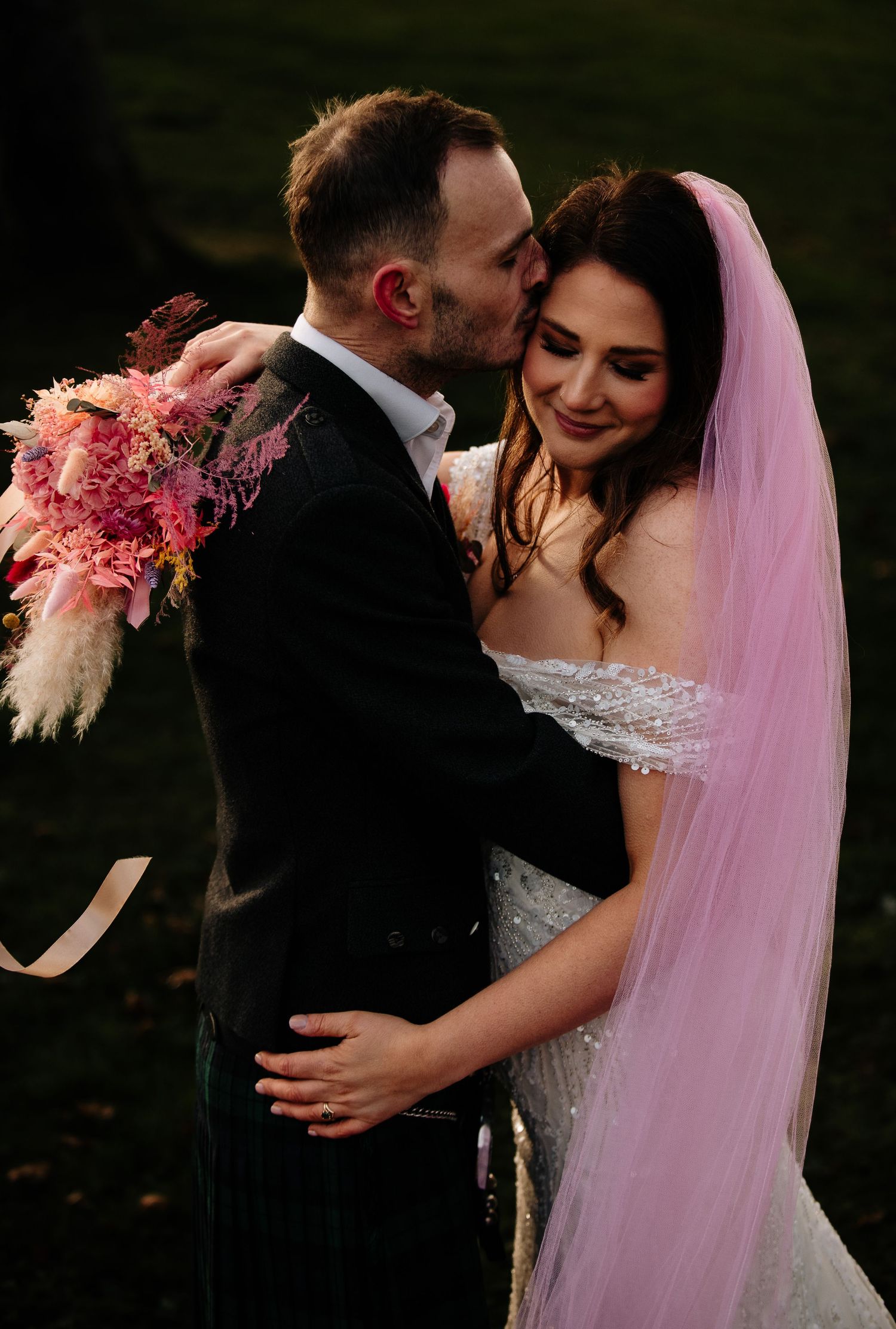 Intimate wedding portraits with pink pampas grass bouquet at dusk.