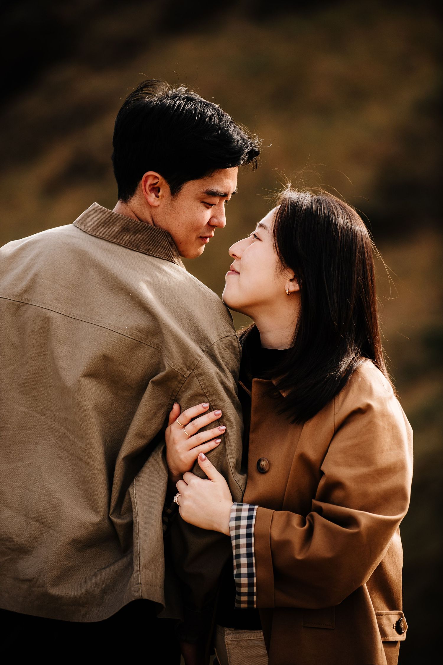 Intimate moment captured between couple in warm autumn light.