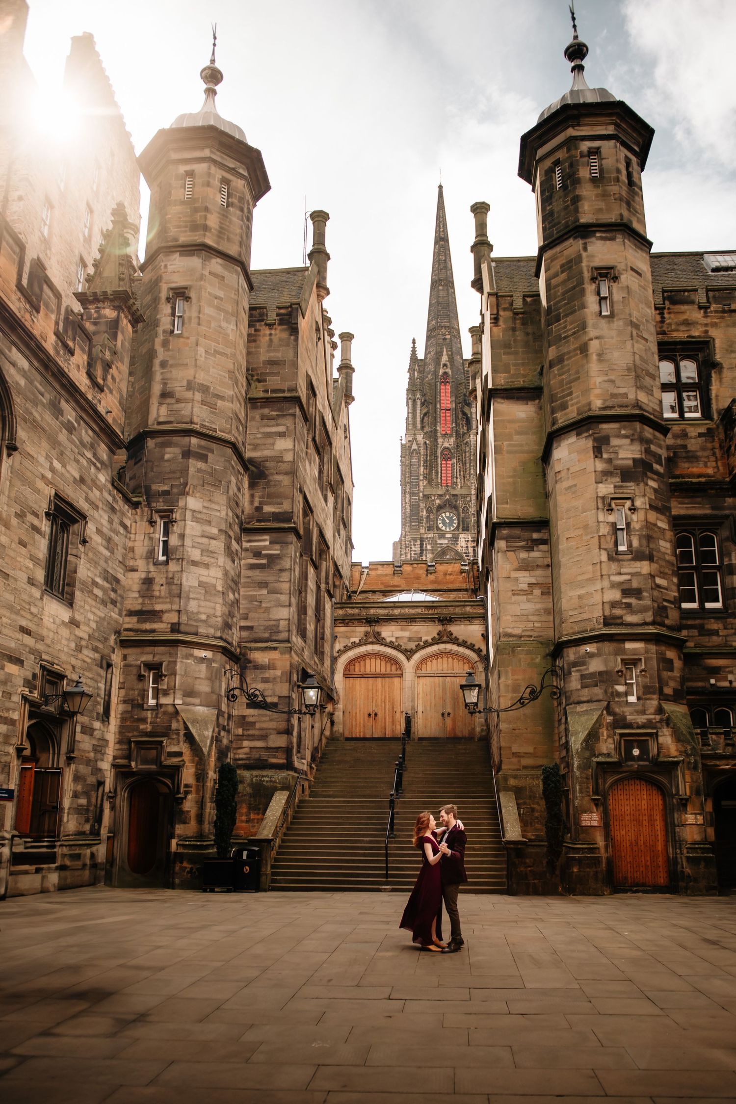 Historic stone courtyard at Edinburgh Castle with gothic architecture and stone steps under moody Scottish skies.