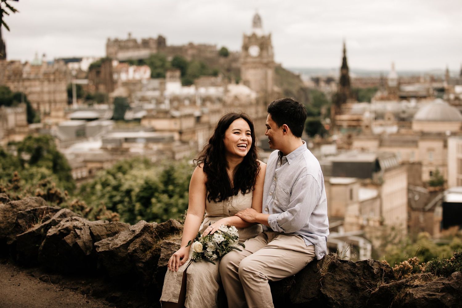 Scenic engagement photo at Calton Hill overlooking Edinburgh's historic architecture.