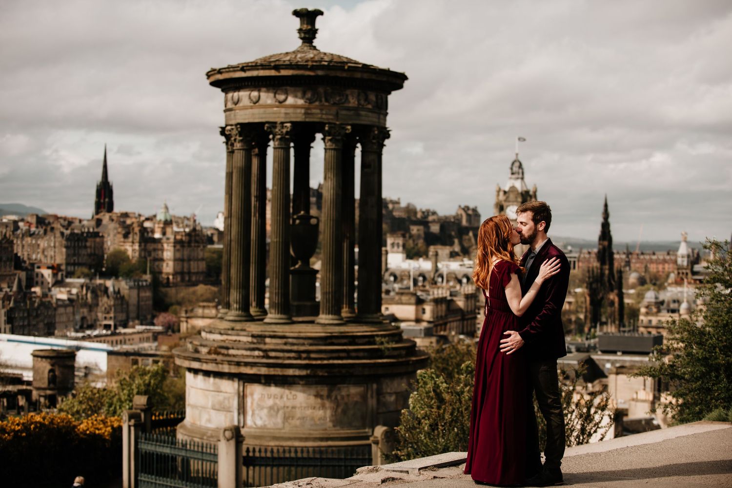 Scenic Edinburgh cityscape view from Calton Hill with the historic monument and architecture at sunset.