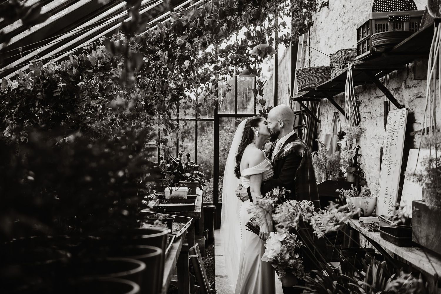Black and white photo of an outdoor garden wedding ceremony.