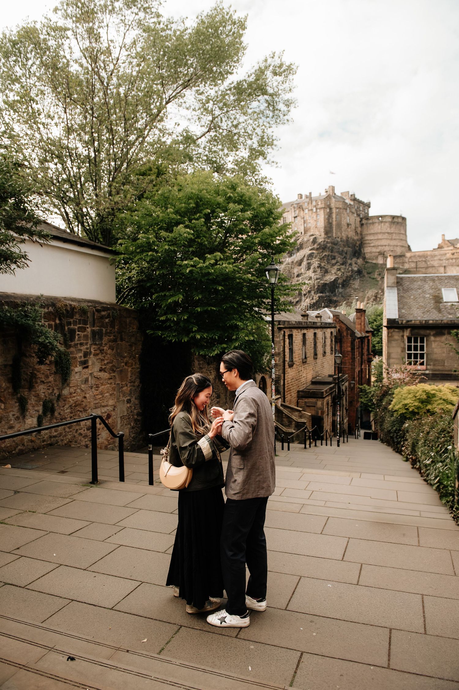 A romantic moment captured on Edinburgh's historic Royal Mile with the castle rising above.