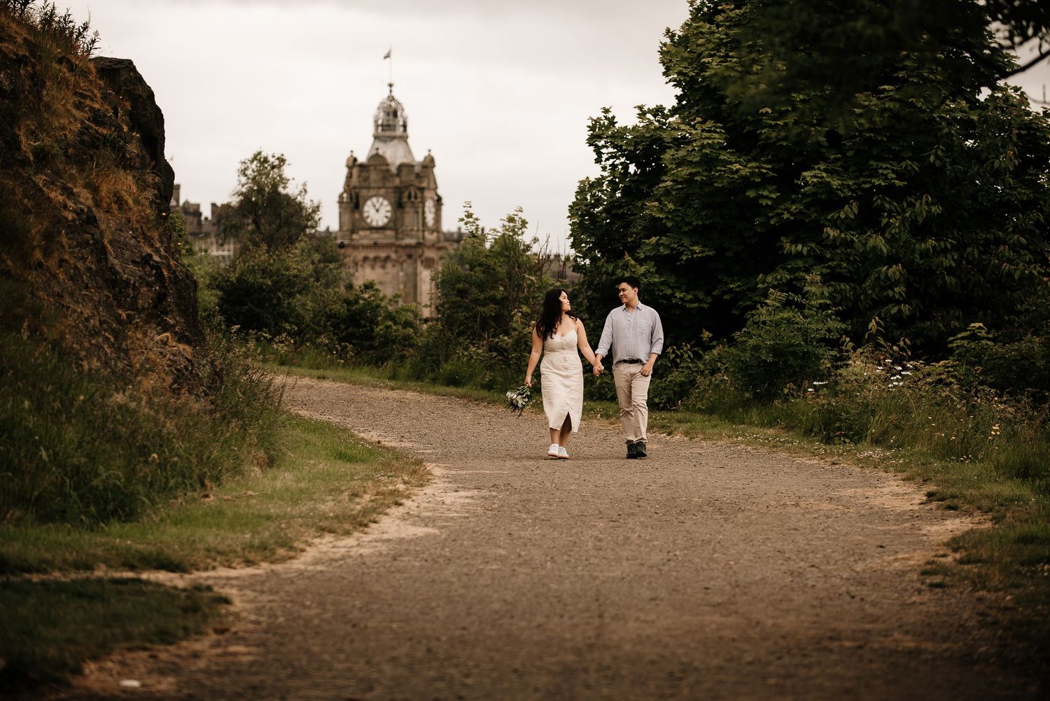 Walking path leading to St Giles Cathedral in Edinburgh with couple strolling.