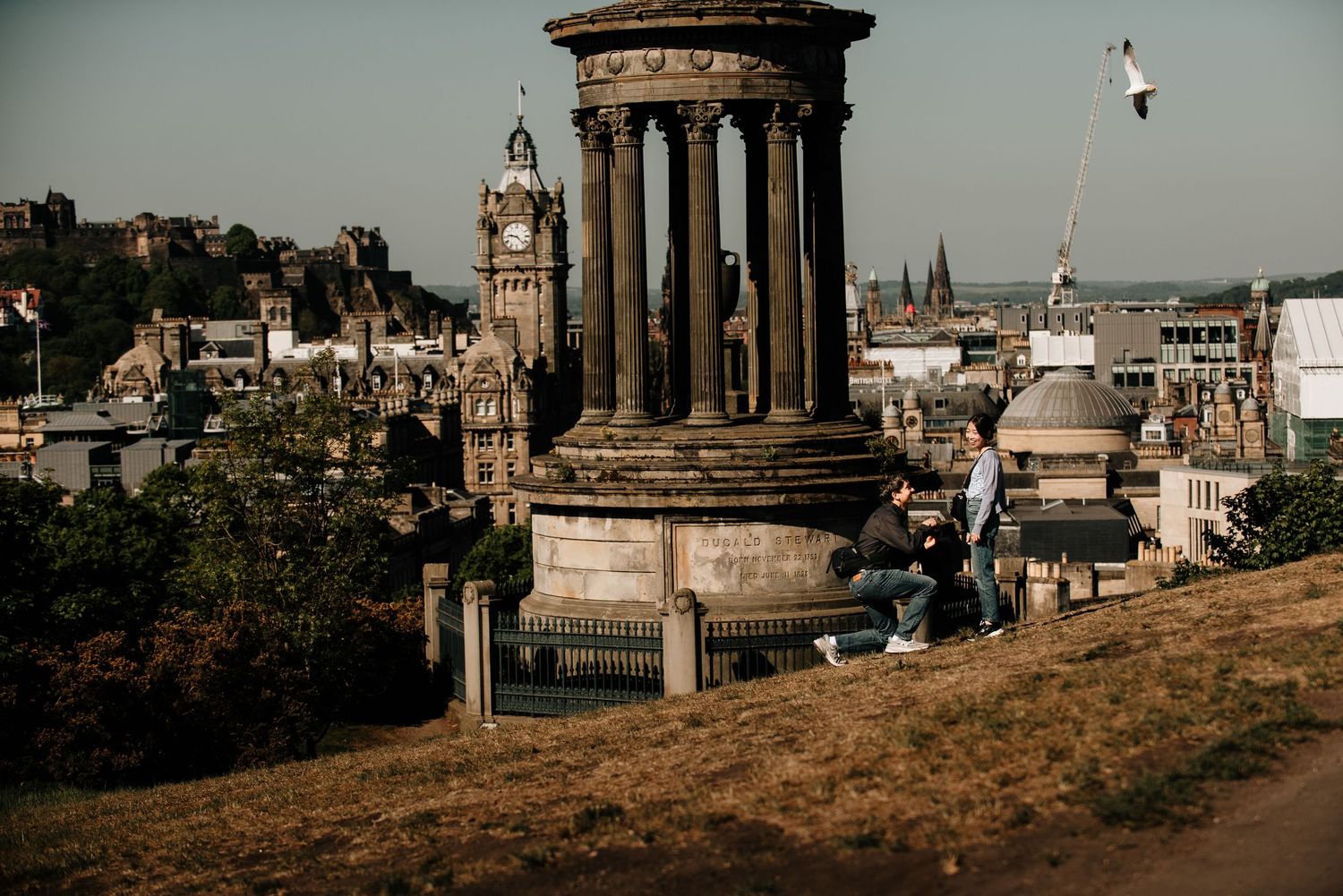 Edinburgh's iconic skyline featuring historic monuments and architecture against a moody sky.