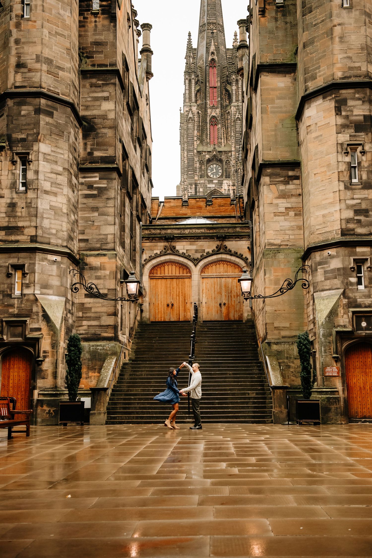Historic stone architecture and steps of Edinburgh's Royal Mile with Gothic spires visible in the background.