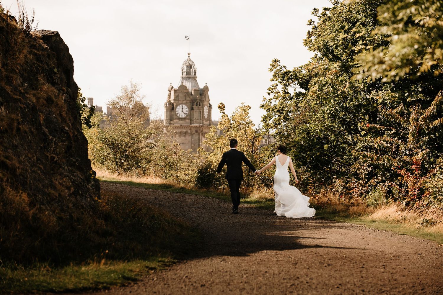 Romantic pathway leading to Edinburgh monuments during a fall engagement session.