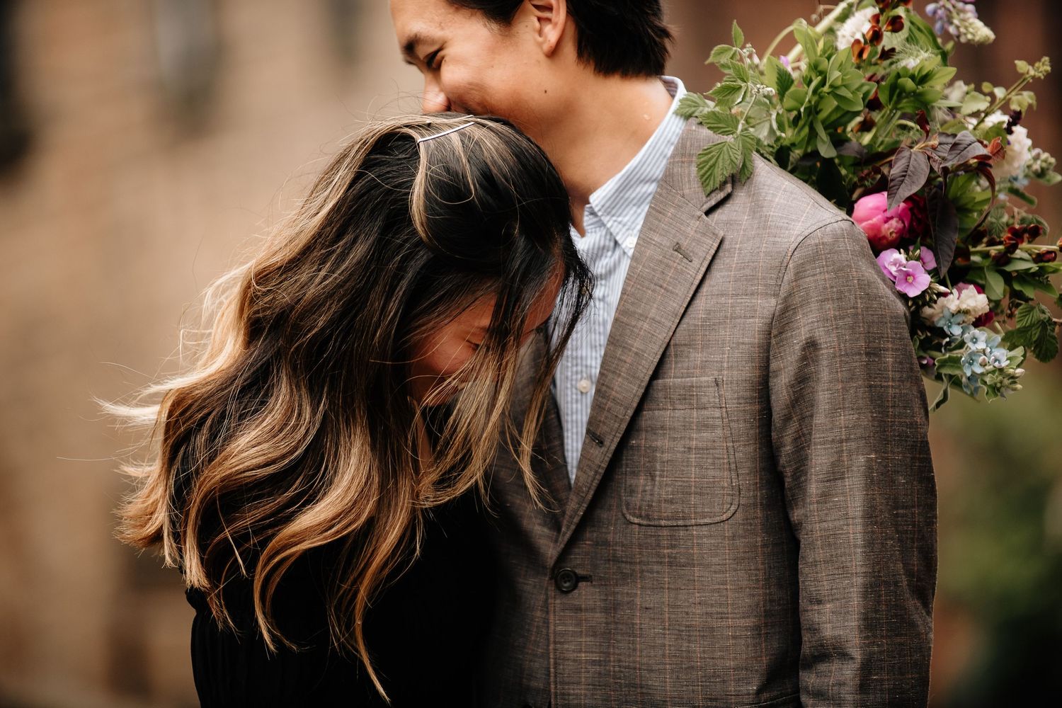 Close-up romantic portrait with soft lighting and natural foliage.