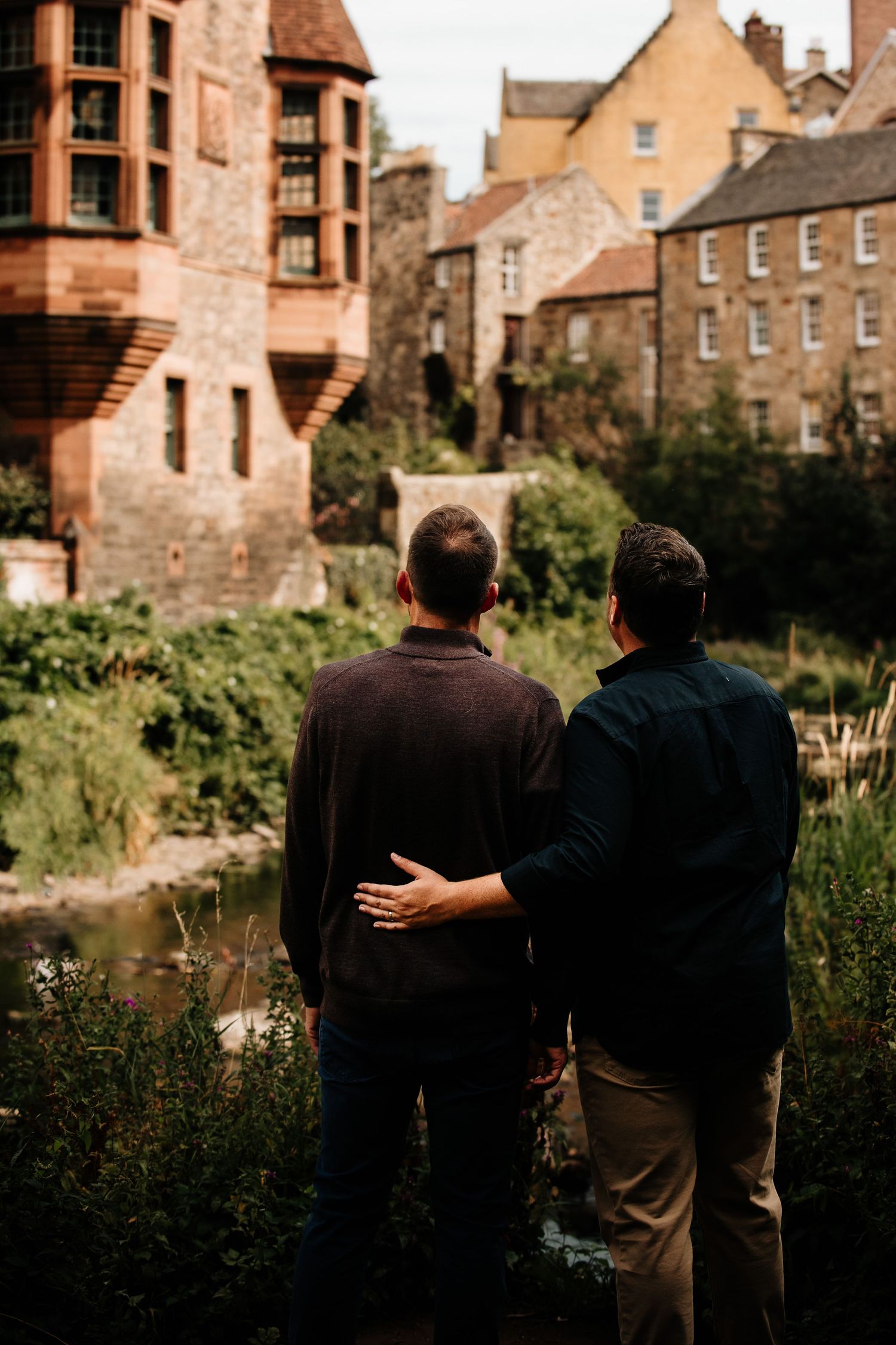 Couple enjoying a quiet moment together against the backdrop of historic Dean Village buildings.