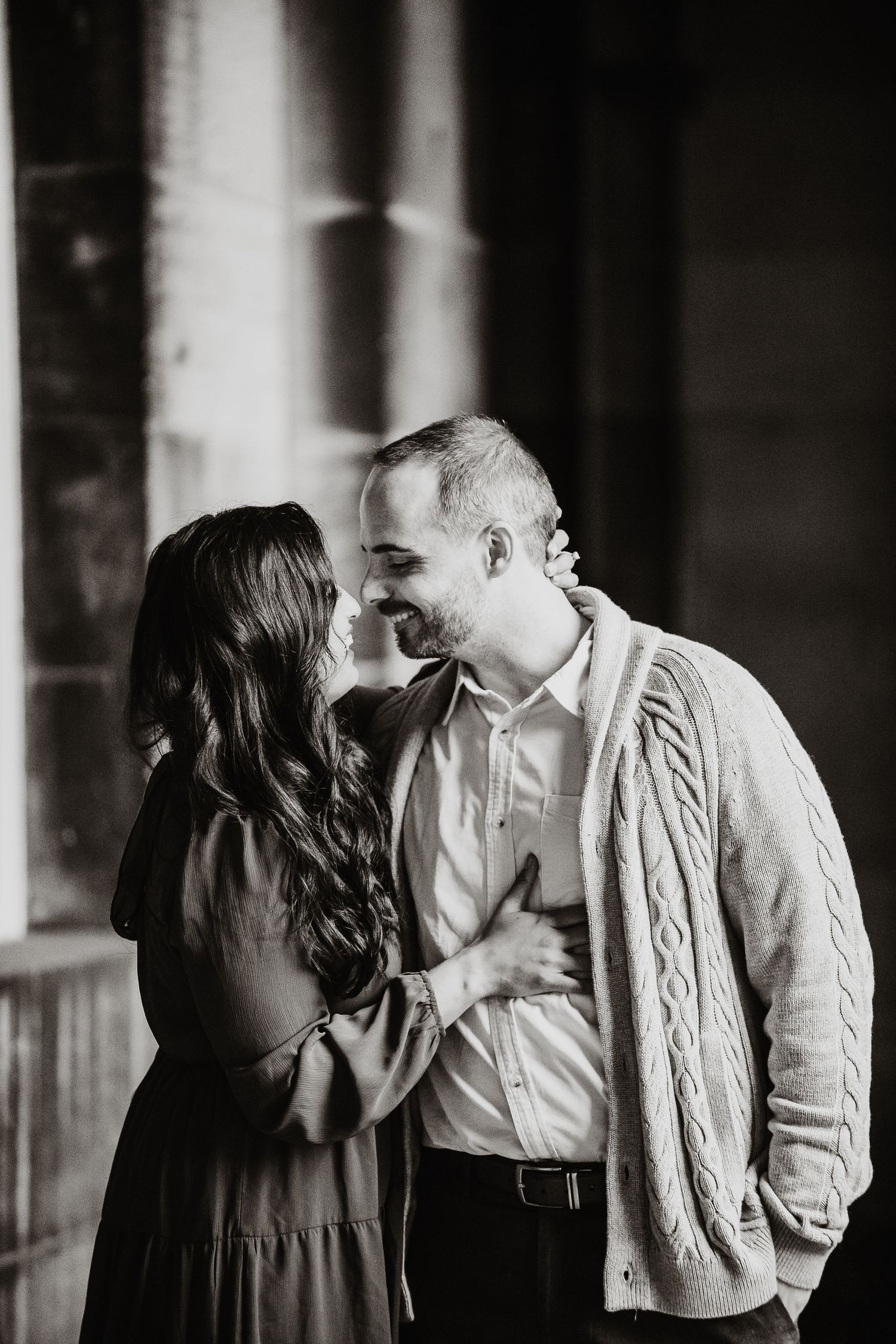 A romantic black and white photo series showing a couple embracing and kissing in an intimate sequence.