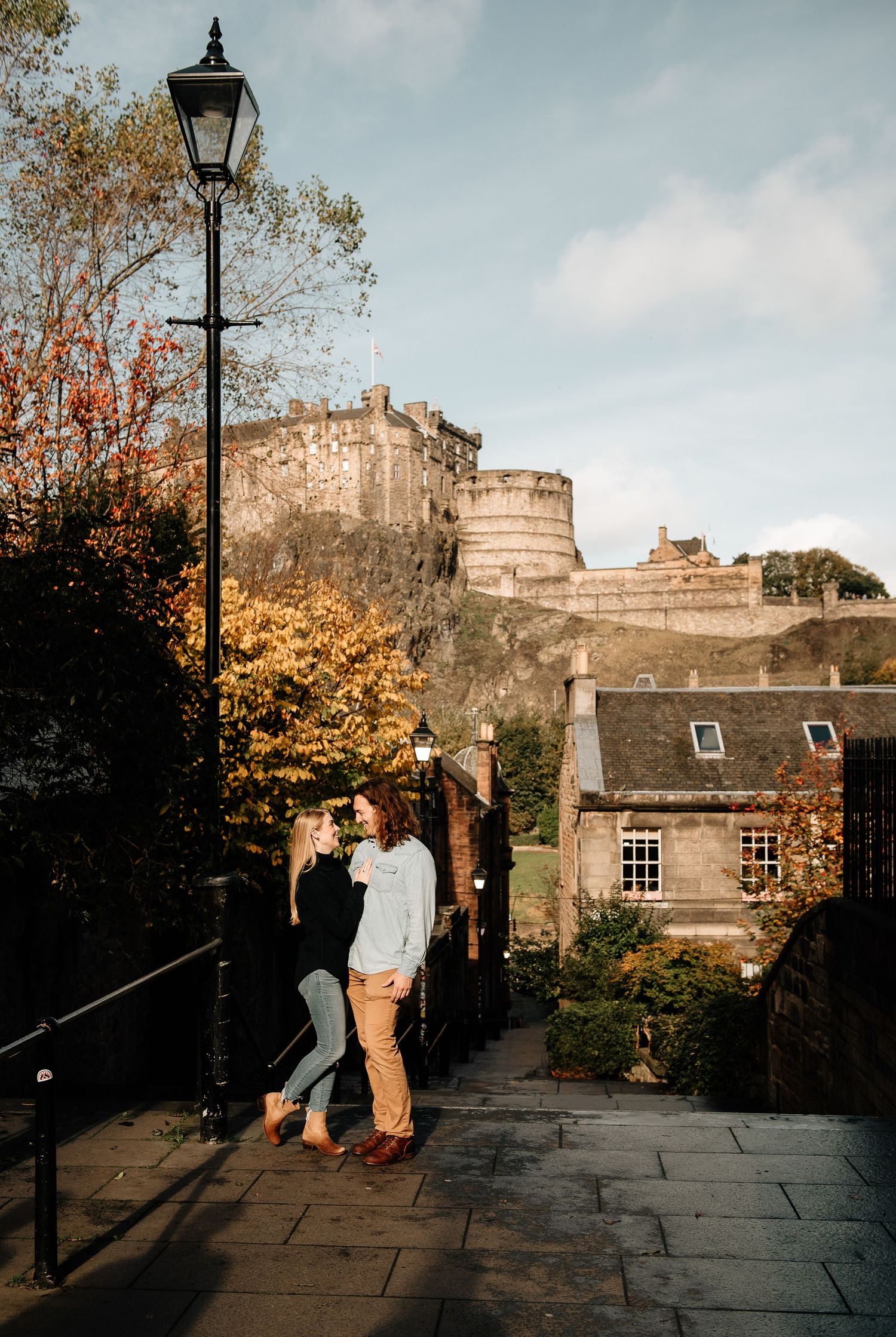 Autumn afternoon at Edinburgh Castle with historic lampposts and stone walls.