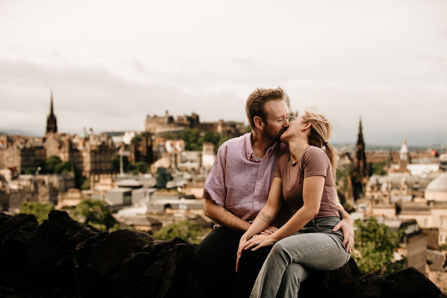 Edinburgh cityscape view with historic architecture and church spires at sunset.