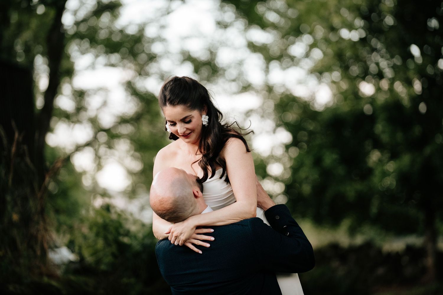 Romantic moment captured in a lush garden setting during a wedding.