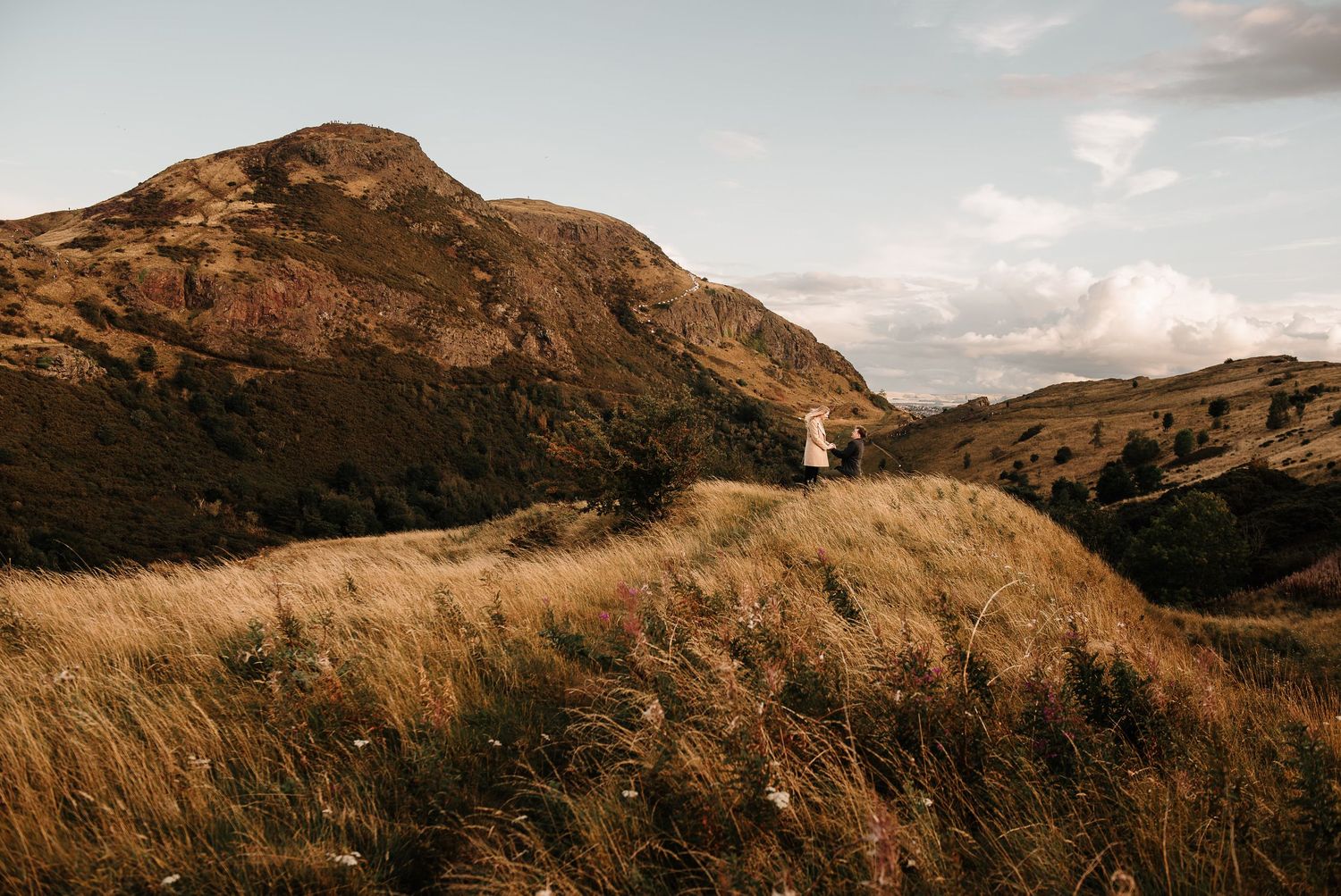 Panoramic view of rugged Scottish mountains under cloudy skies.