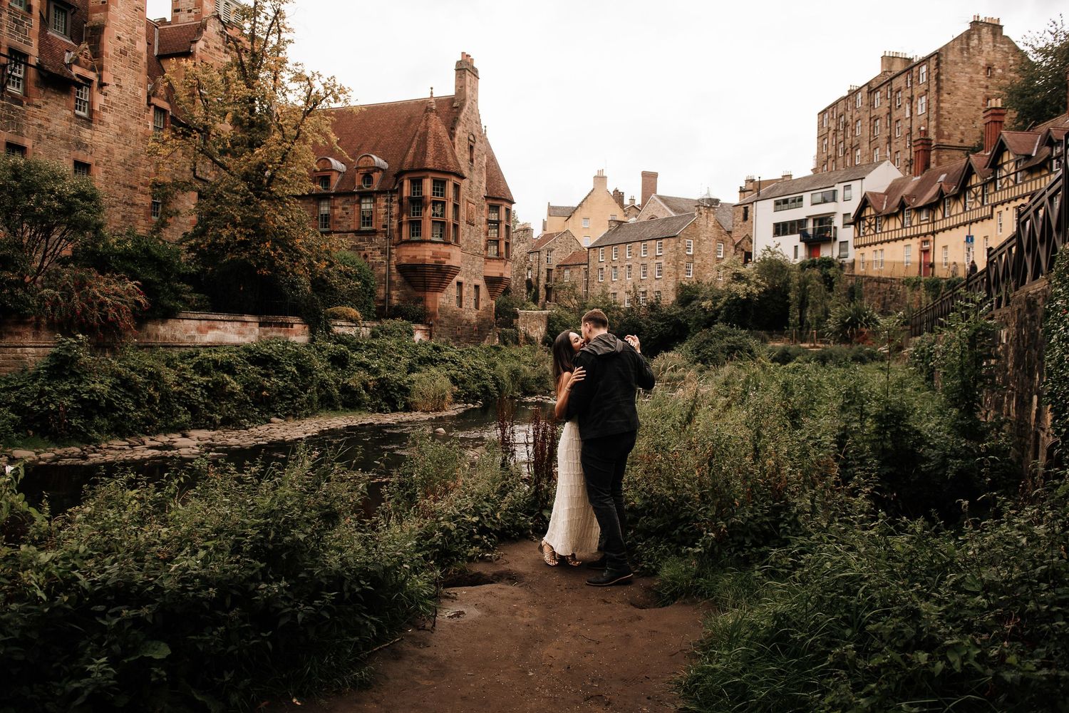 Wide angle view of romantic photoshoot in historic Dean Village with stone architecture.