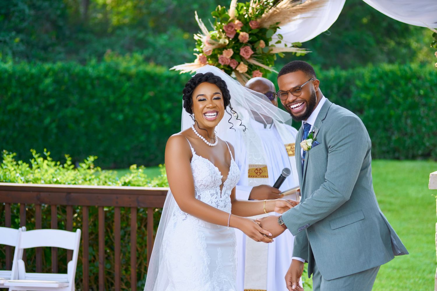 Wedding celebration in a lush garden setting with floral decorations.