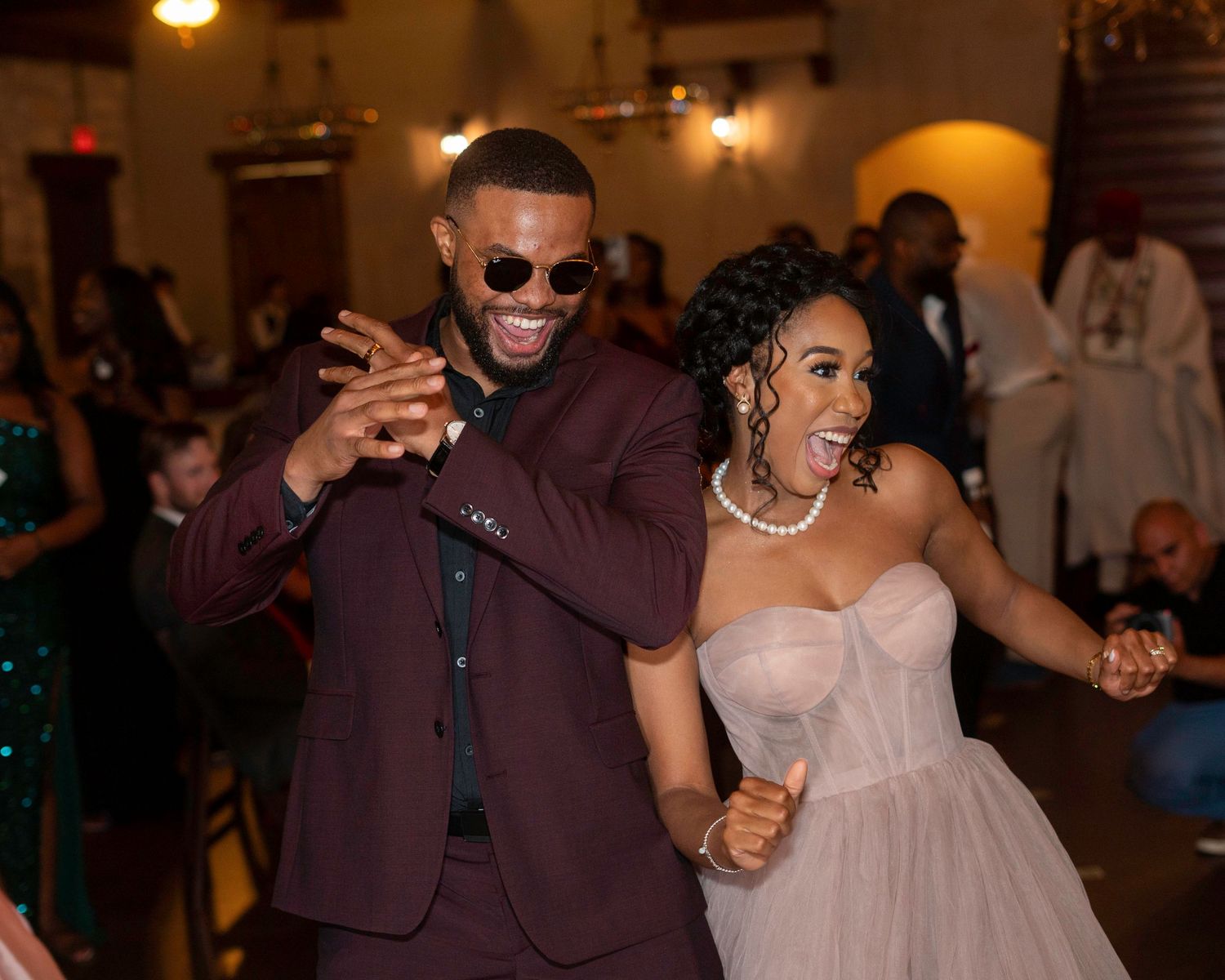Newlyweds share joyful dance moves at their indoor reception.