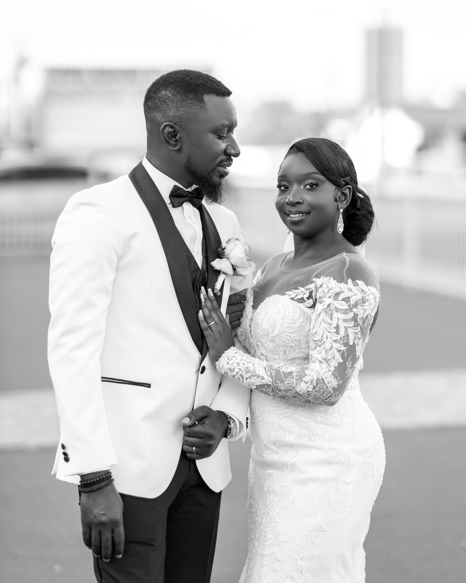 A wedding couple shares intimate moments in black and white photography.