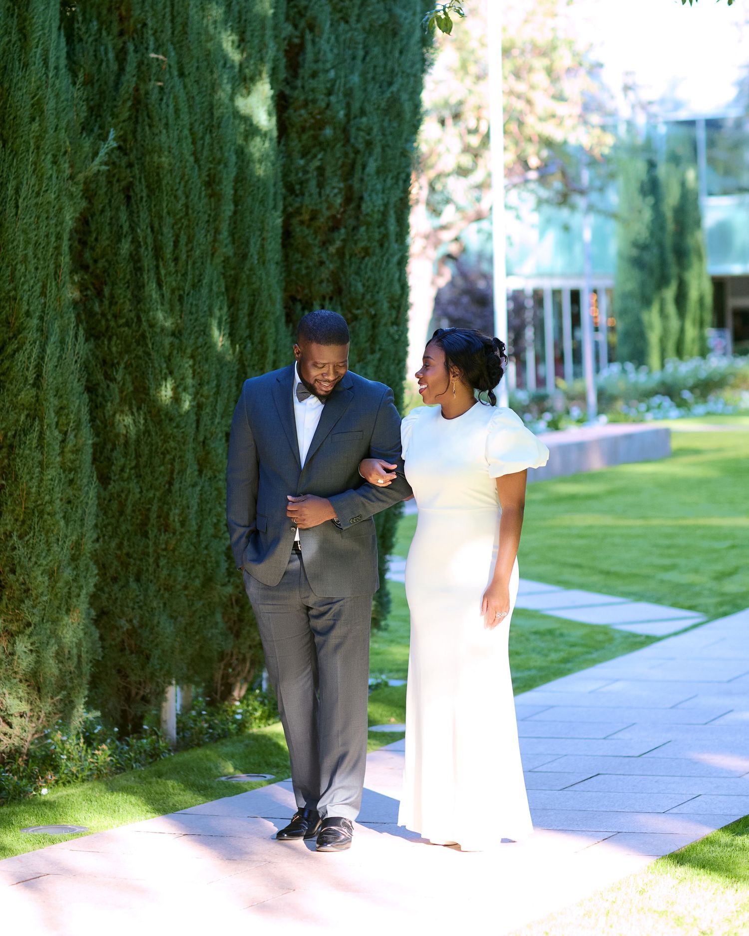 Playful outdoor photoshoot sequence showing couple hiding behind trees.