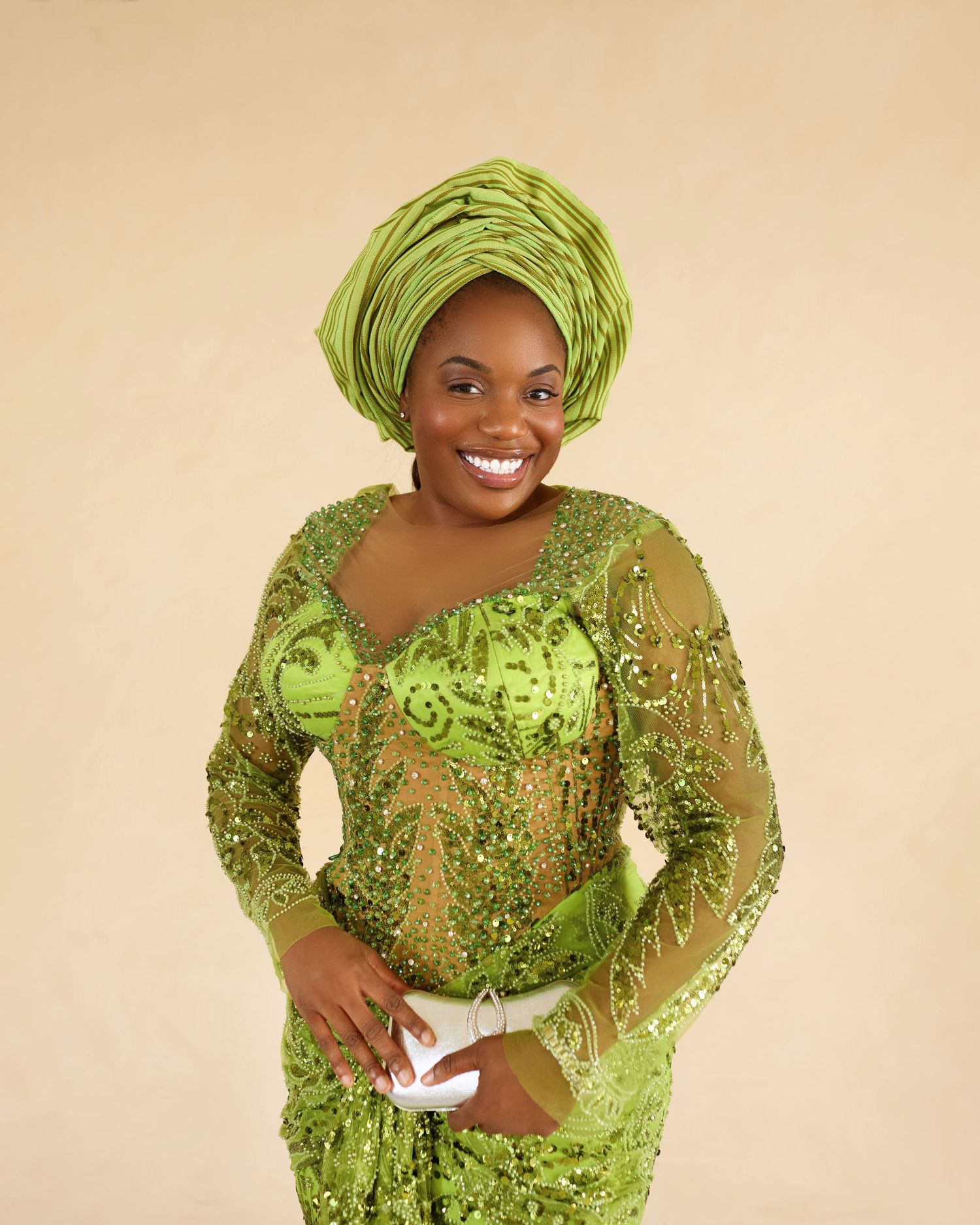 Portrait series in ornate lime green traditional dress with matching headwrap against neutral background.