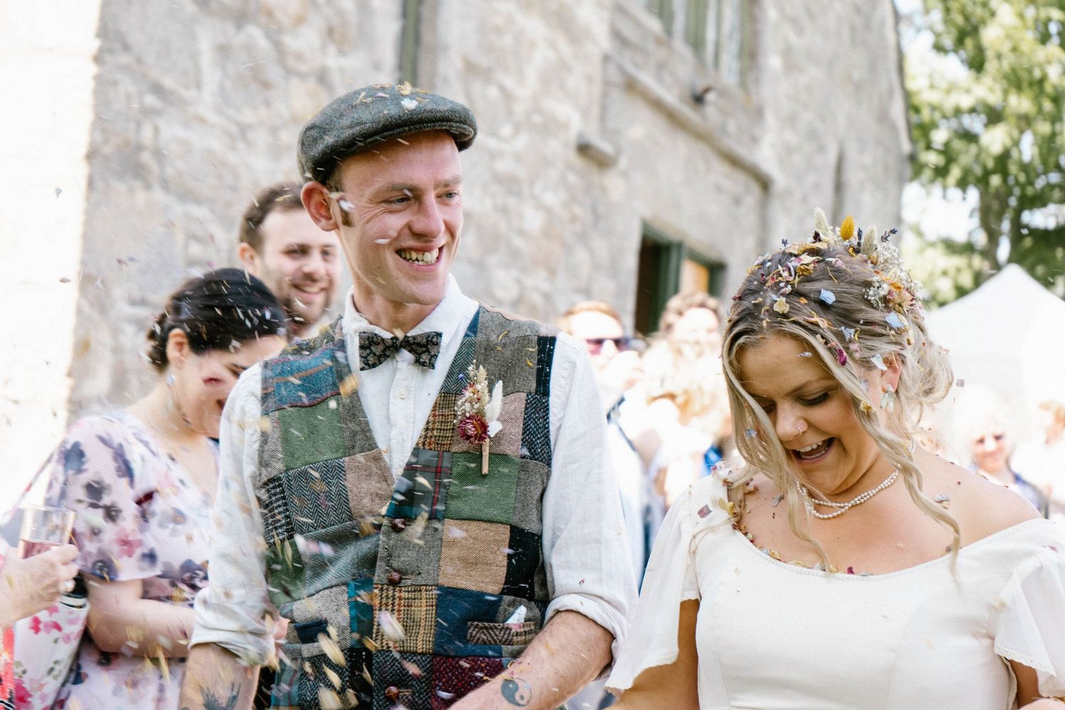 Joyful celebration with confetti at an outdoor wedding.